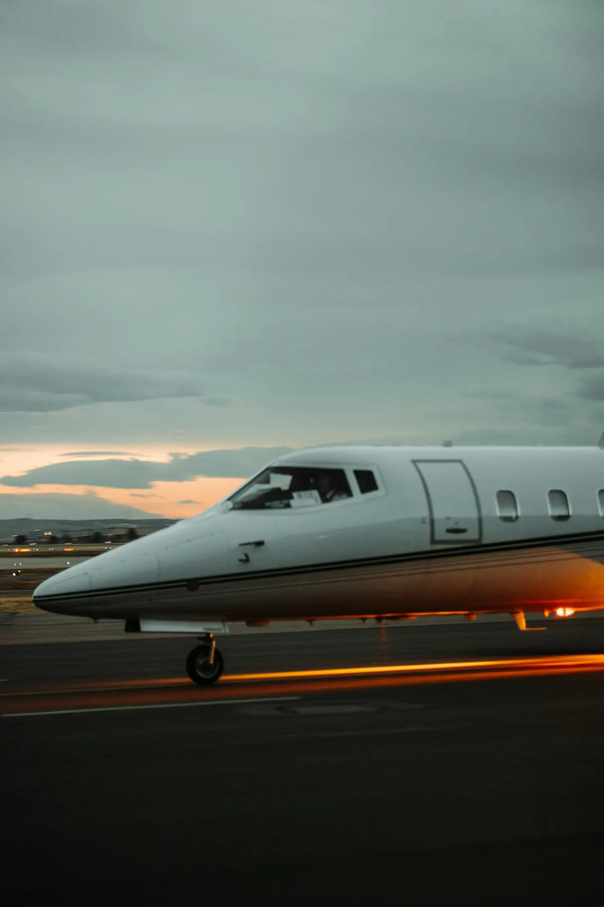 Midsize jet parked on the ramp at dusk